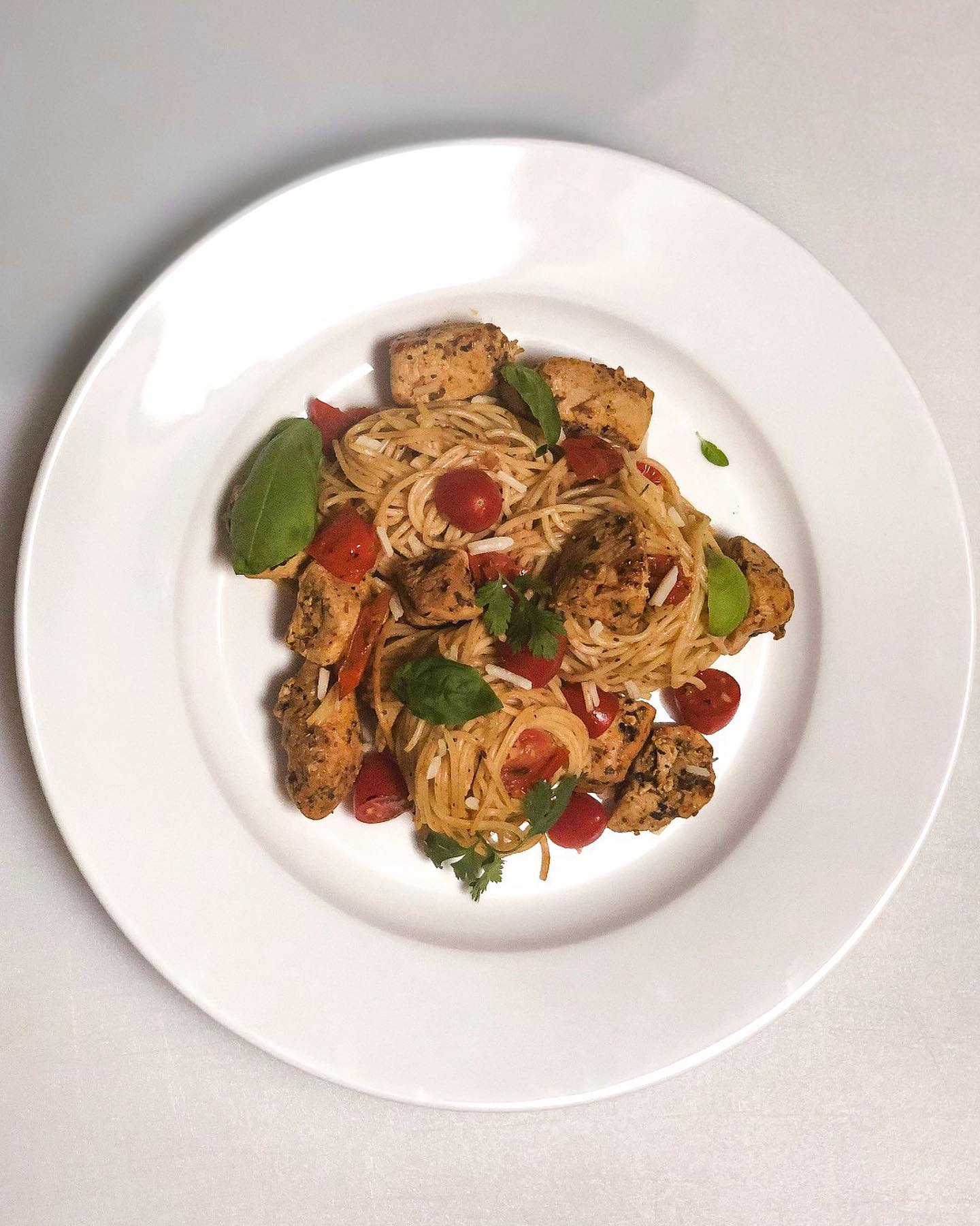 Elegantly plated pasta with fresh herbs and protein